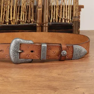 Close-up detail of the retro brown leather belt featuring ornate silver carved metal buckle.