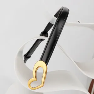 Women's slim black leather belt featuring an elegant gold heart buckle for dresses and coats.