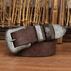 Vintage genuine leather belt detail shot with ornate floral engraved silver metal buckle.