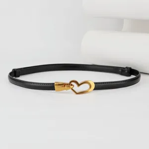 Close-up detail view of the thin black leather waist belt featuring a stylish gold heart buckle.