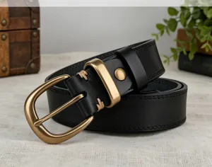 Vintage women's black leather belt detail, featuring antique brass buckle and neat stitching.