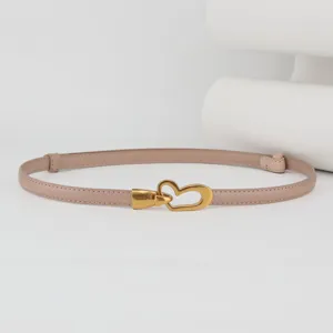 Slim leather belt for women with elegant gold heart buckle. Perfect dress accessory.