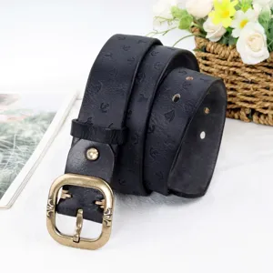 Vintage leather belt detail shot showing embossed anchor pattern and bronze metal buckle.