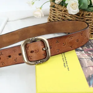 Vintage genuine leather belt detailed view showing embossed pattern and retro metal buckle.