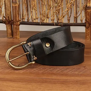Close-up detail of black genuine leather men belt with vintage brass horseshoe metal buckle.