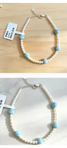 Detailed view of natural blue Larimar beads and white freshwater pearls on a handmade bracelet.