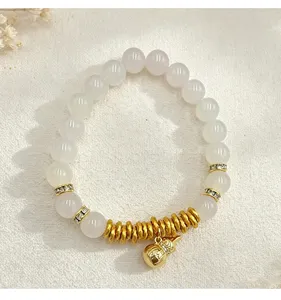 Macro view of crystal beaded bracelet with gold Wu Lou gourd pendant and stone spacers
