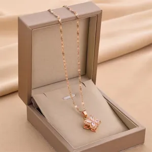 Elegant rose gold four-petal flower pendant necklace displayed in a premium jewelry box