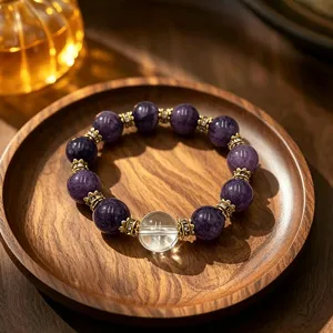 Handmade natural amethyst crystal beaded bracelet for women on a rustic wooden tray