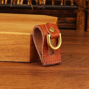 Detailed view of handmade genuine leather belt key holder with metal ring and brass snap.