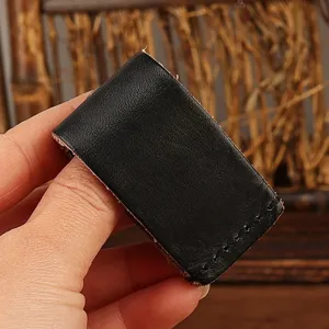 Handmade genuine leather belt key holder detail close-up, showing fine stitching texture.