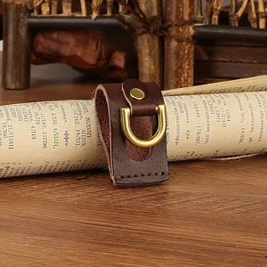 Handmade cowhide belt loop key holder detail, premium leather with brass D-ring hook.
