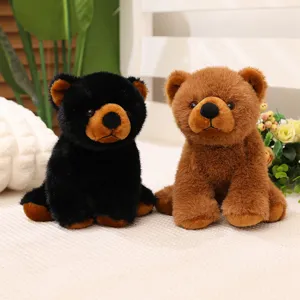 Vue détaillée de peluches d'ours réalistes noires et brunes assises sur une surface douce