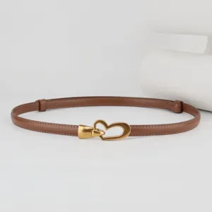Detailed view of the women thin brown leather belt featuring a stylish gold heart metal buckle.