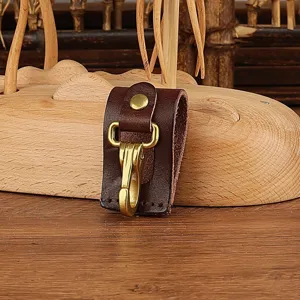 Detailed close-up of a durable brown leather belt key holder featuring solid brass hook.