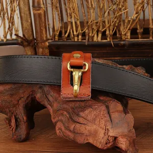 Leather belt key holder with brass hook, durable vintage waist key clip accessory for daily use.