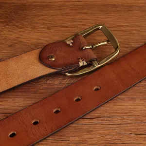 Detailed view of vintage brown leather belt with metal pin buckle and stitching accents