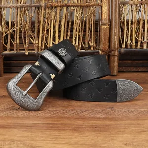 Detailed view of retro genuine leather embossed belt with silver carved floral metal buckle and tip.