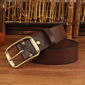 Close-up detail of brown leather belt with vintage metal buckle and rustic stitching.