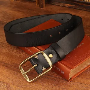Detailed shot of a vintage black leather belt with classic metal pin buckle on old books.
