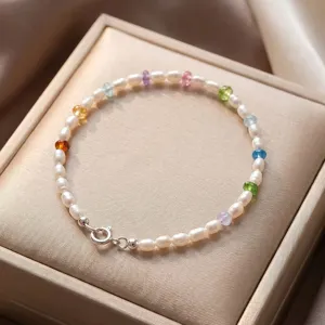 Detailed macro shot of natural pearl bracelet with colorful gemstone beads in a gift box