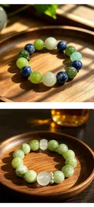 Detailed view of natural green fluorite and colorful crystal beaded bracelets on wooden tray