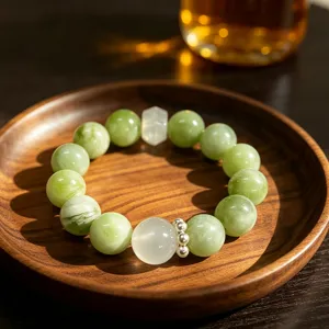 Natural green fluorite crystal beaded bracelet with elegant wooden tray presentation scene