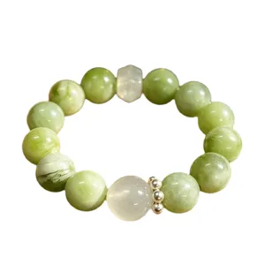 Natural green fluorite crystal beaded bracelet with translucent white accent bead.