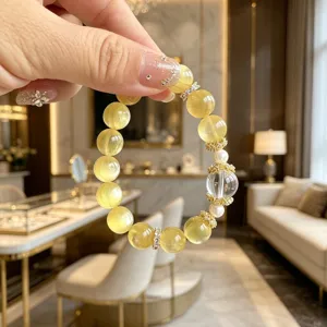 Nahaufnahme eines goldenen Lepidolith-Armbands mit eleganten Kristallakzenten