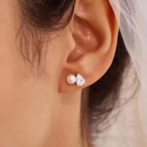 Detailansicht eines eleganten Goldohrsteckers mit weißer Perle und tropfenförmigem Zirkonia-Stein