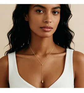 Detailansicht einer eleganten goldenen Y-Halskette mit Tropfenanhänger, von Model getragen