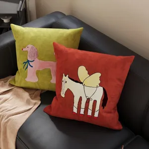 Detailed close-up of vintage cartoon throw pillows featuring cute dog and horse on sofa.