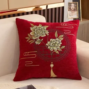 Chinese style red embroidered cushion detail showcasing delicate peony and cloud patterns.
