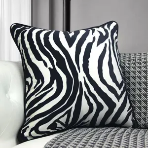 Detail shot of modern black and white zebra pattern cushion cover for sofa and home decor use.