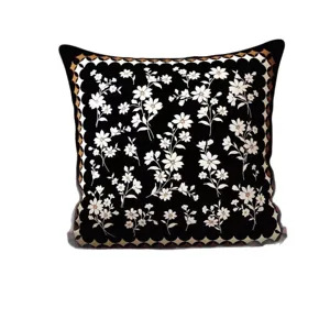 Vintage floral throw pillow with black base and classic geometric border, soft sofa cushion.