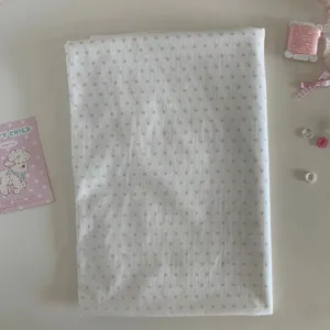 Pink star pattern white fabric detail shot, cute background cloth for photography and DIY crafts.