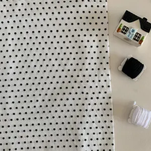 White fabric with black star pattern, cute photography background cloth for desktop and table.