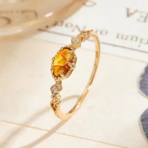 Macro view of vintage S925 gold-plated ring with oval amber chalcedony gemstone