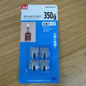 Detailansicht von 4 Mini-Edelstahl-Klebehaken in blauer Einzelhandelsverpackung