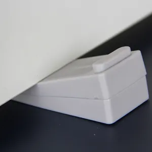 Grey wedge-shaped plastic door stopper with non-slip texture for home floor security