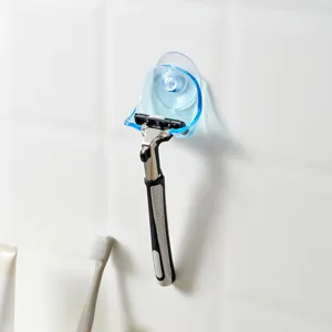Blue suction cup razor holder for bathroom wall storage with manual razor displayed