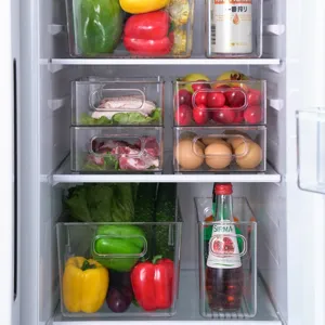 Set of clear stackable refrigerator organizer bins with handles for fresh food storage.