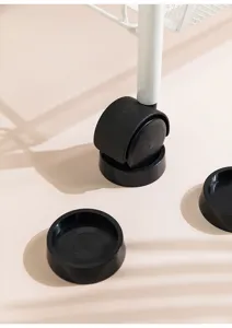 Detail view of black non-slip furniture caster cups for wheel stabilization.