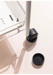 Close-up of black anti-slip caster cups securing a white furniture trolley wheel