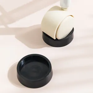 Set of 2 non-slip black caster cups for office chair wheels and furniture rollers.