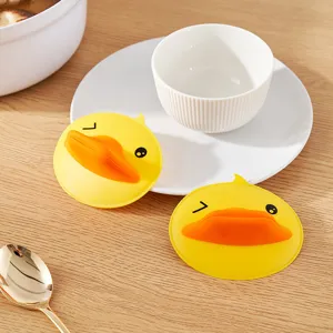 Pair of cute yellow duck silicone oven mitts for heat insulation in kitchen