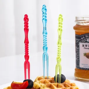 Creative colorful plastic fruit forks for desserts and cakes shown in a lifestyle setting