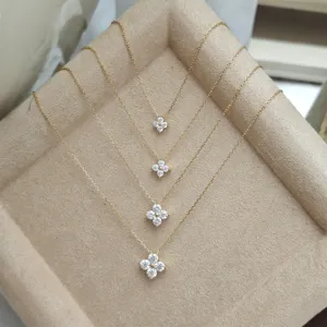 Detailed macro view of four-leaf clover Moissanite necklaces in four different sizes