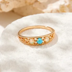 Close-up detail of a vintage S925 gold-plated ring featuring turquoise and opal gemstones