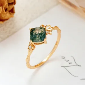 Macro detail of natural moss agate ring with S925 gold-plated sterling silver band.